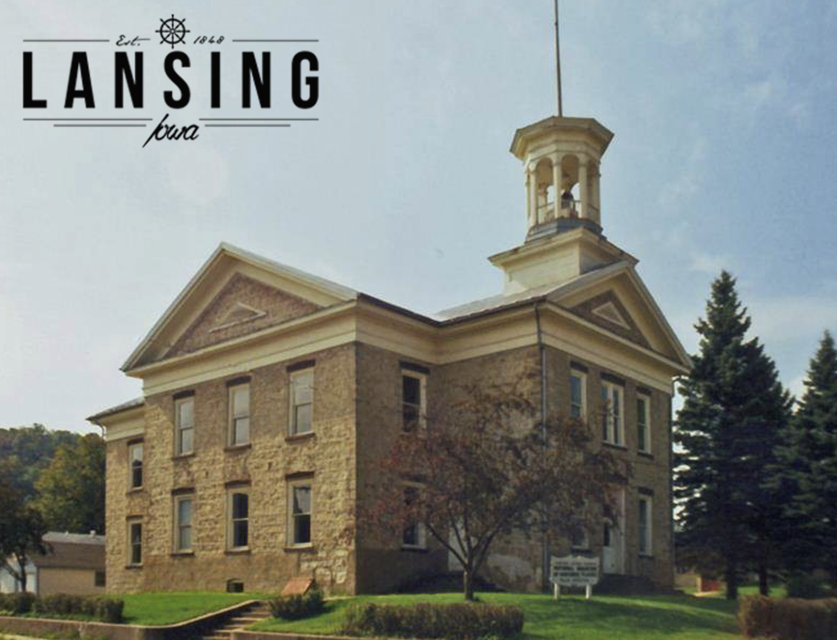 old limestone building with cupola and the title "Lansing"