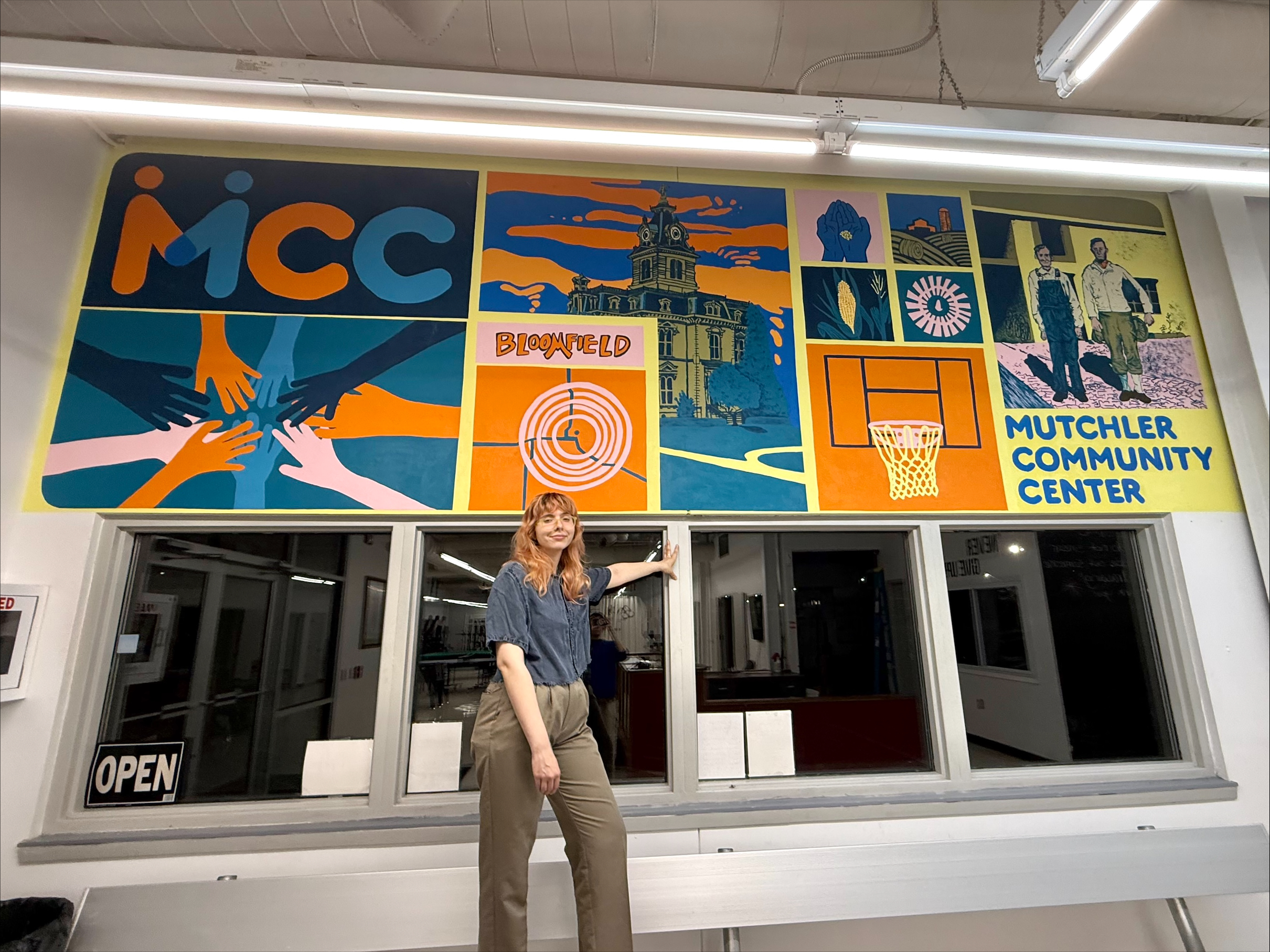 Emily Edwards standing in front of mural