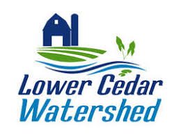 icon of a blue barn with green grass and a blue river flow in front with the words Lower Cedar Watershed