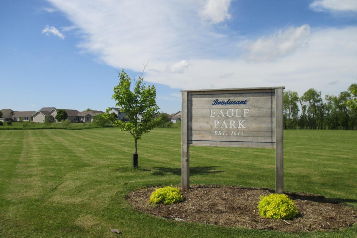 A wooden park sign that reads Eagle Park