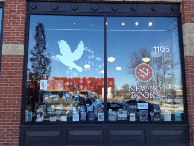 The display window of NewBo books featuring books and a white dove graphic