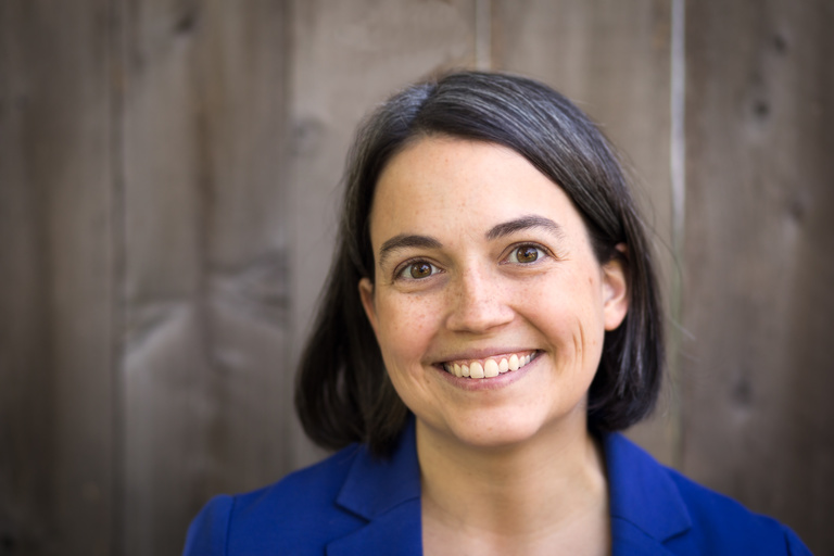 headshot of woman in blue shirt