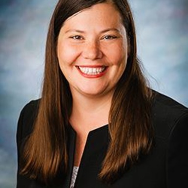headshot of white woman with long brown hair