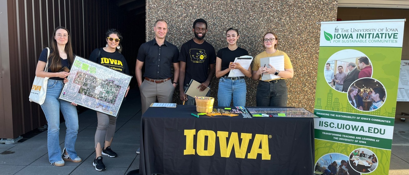Group of young people in front of a table that says Iowa