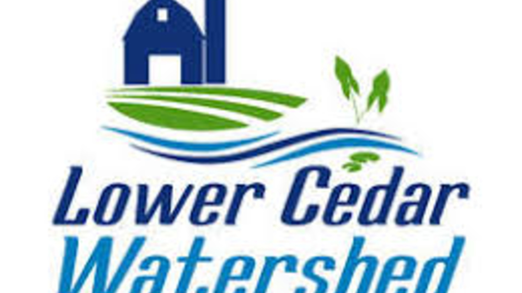 icon of a blue barn with green grass and a blue river flow in front with the words Lower Cedar Watershed