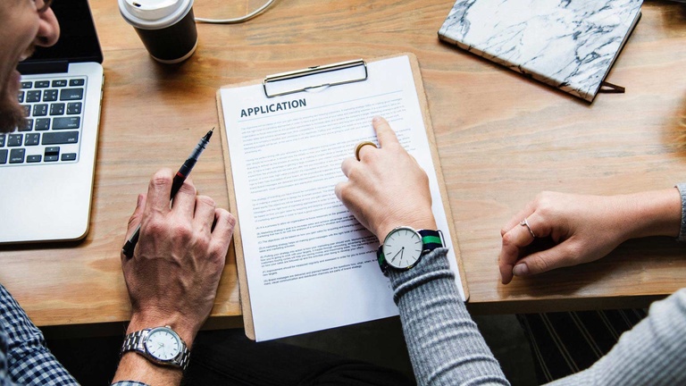 overhead photo of people signing an application