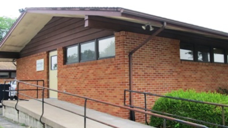 red brick building with an accessibility ramp